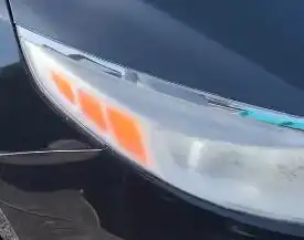 Kia headlight with a cloudy, hazy lens before restoration