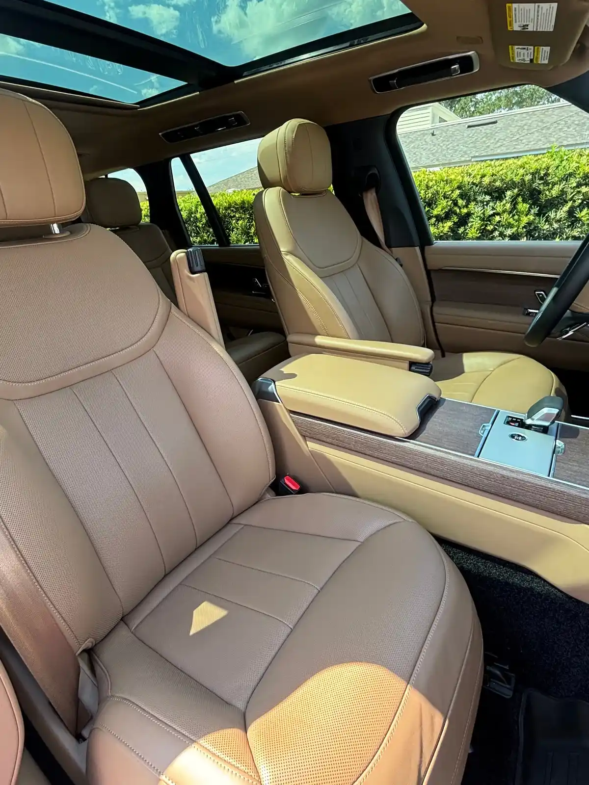 Range Rover caramel leather front seats under the panoramic roof after an interior detail
