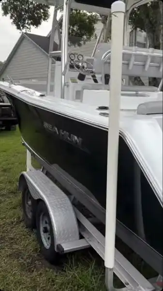 The same Sea Hunt hull after detailing, a deep black gloss under the SEA HUNT lettering