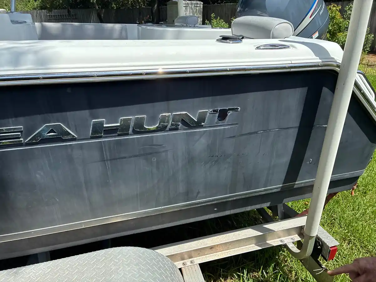 Sea Hunt hull before detailing, faded gray and chalky from oxidation