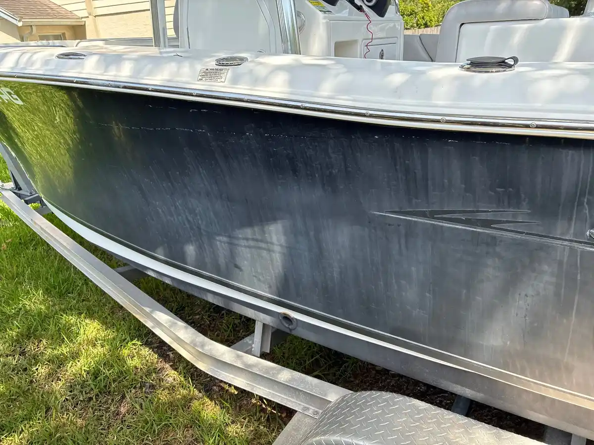 Close-up of the oxidized gelcoat on the Sea Hunt hull before polishing