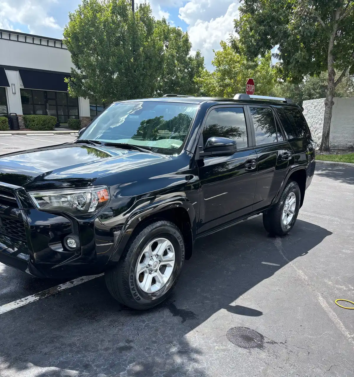 Black Toyota 4Runner gleaming after a wash in a parking lot